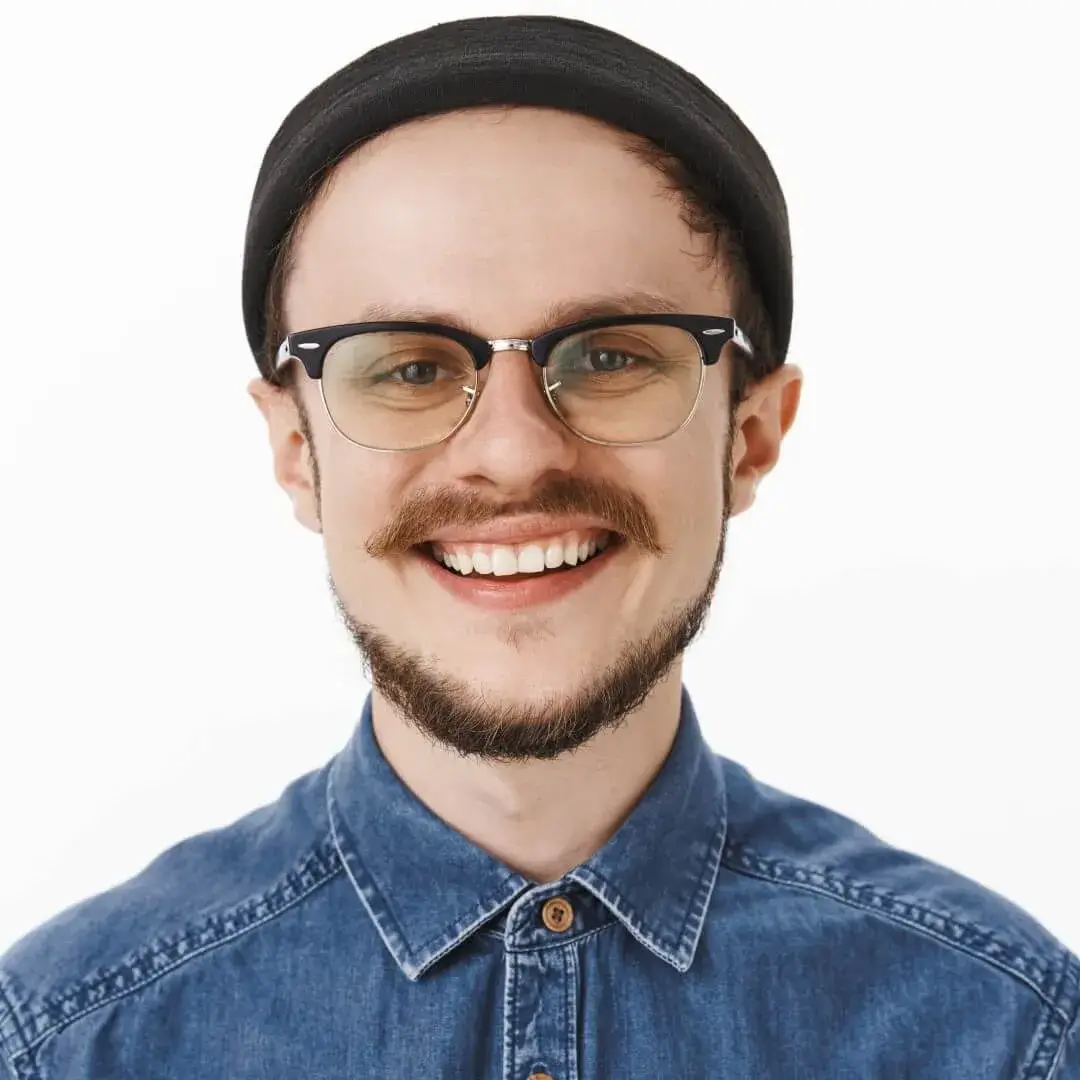 close-up-shot-happy-delighted-charming-young-bearded-man-with-moustache-glasses-black-trendy-beanie-smiling-joyfully-laughing-feeling-satisfied-lucky